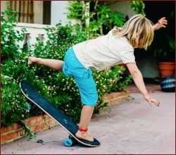 child falling off skateboard
